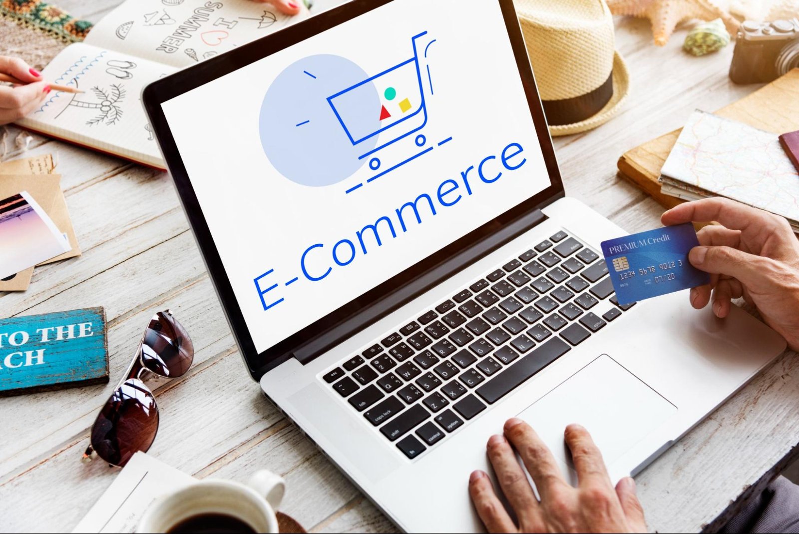 Person holding credit card in front of laptop displaying e-commerce screen, representing WooCommerce starter setup costs.