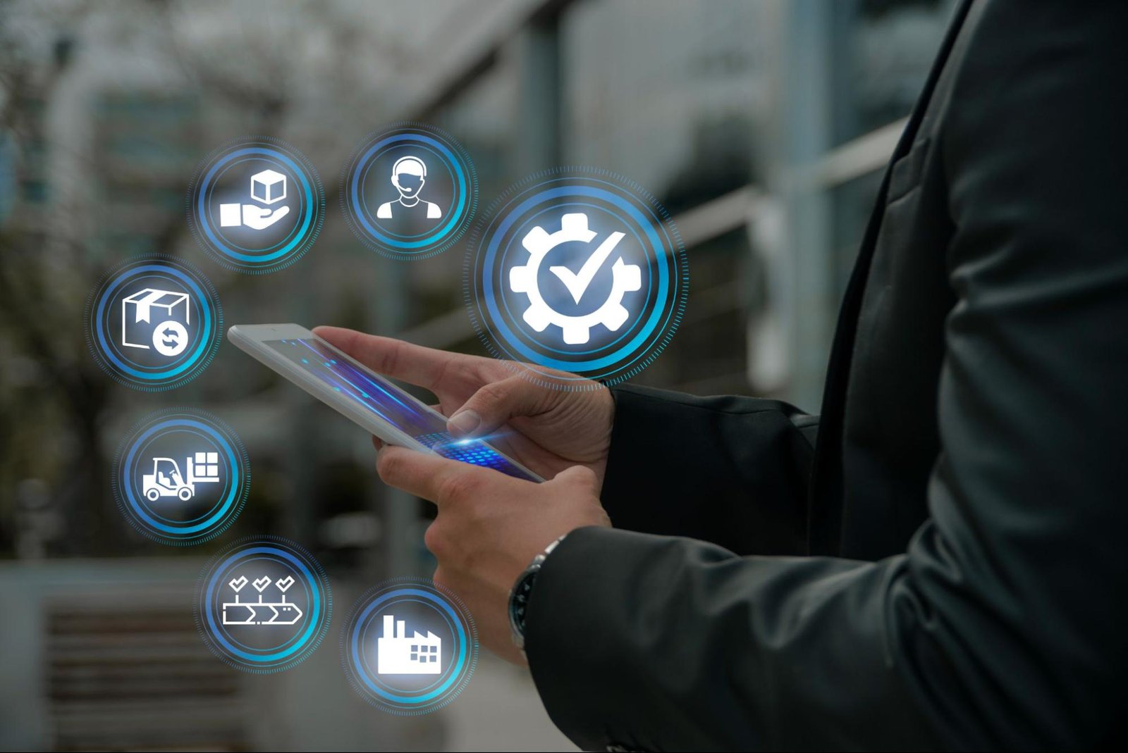Business professional using a mobile device with digital icons for inventory, delivery, and systems—illustrating ERP and inventory integration for ecommerce.