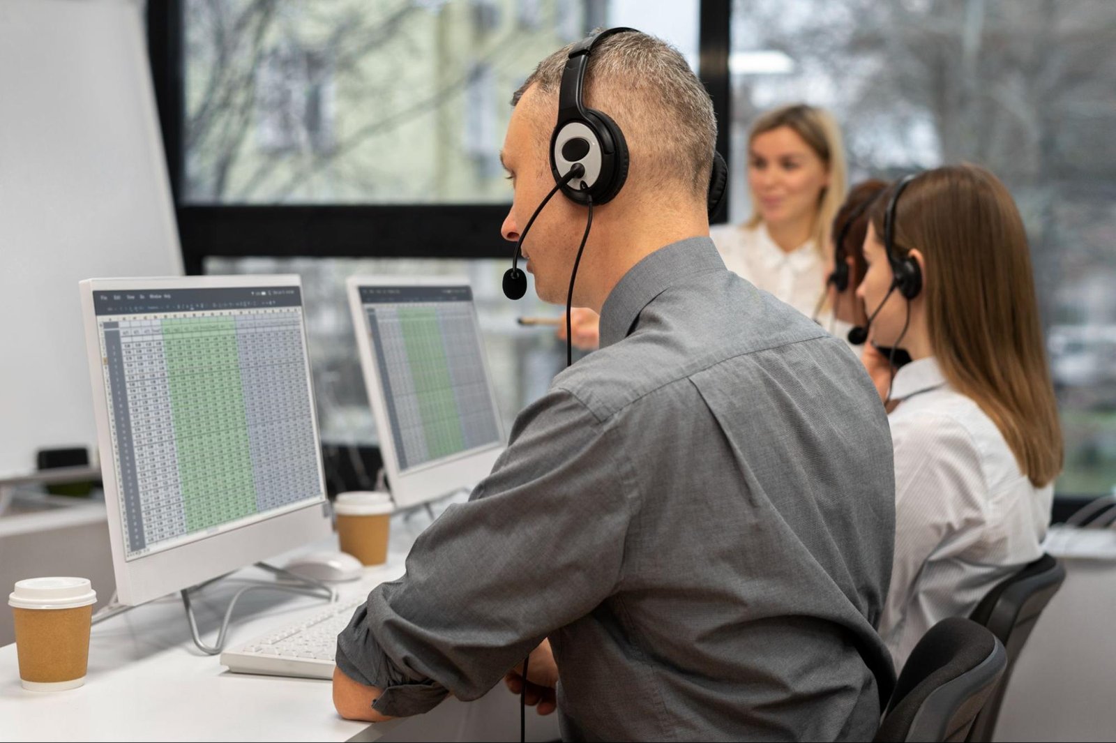 Customer support team working with headsets and spreadsheets, illustrating returns processing and ecommerce customer service operations.